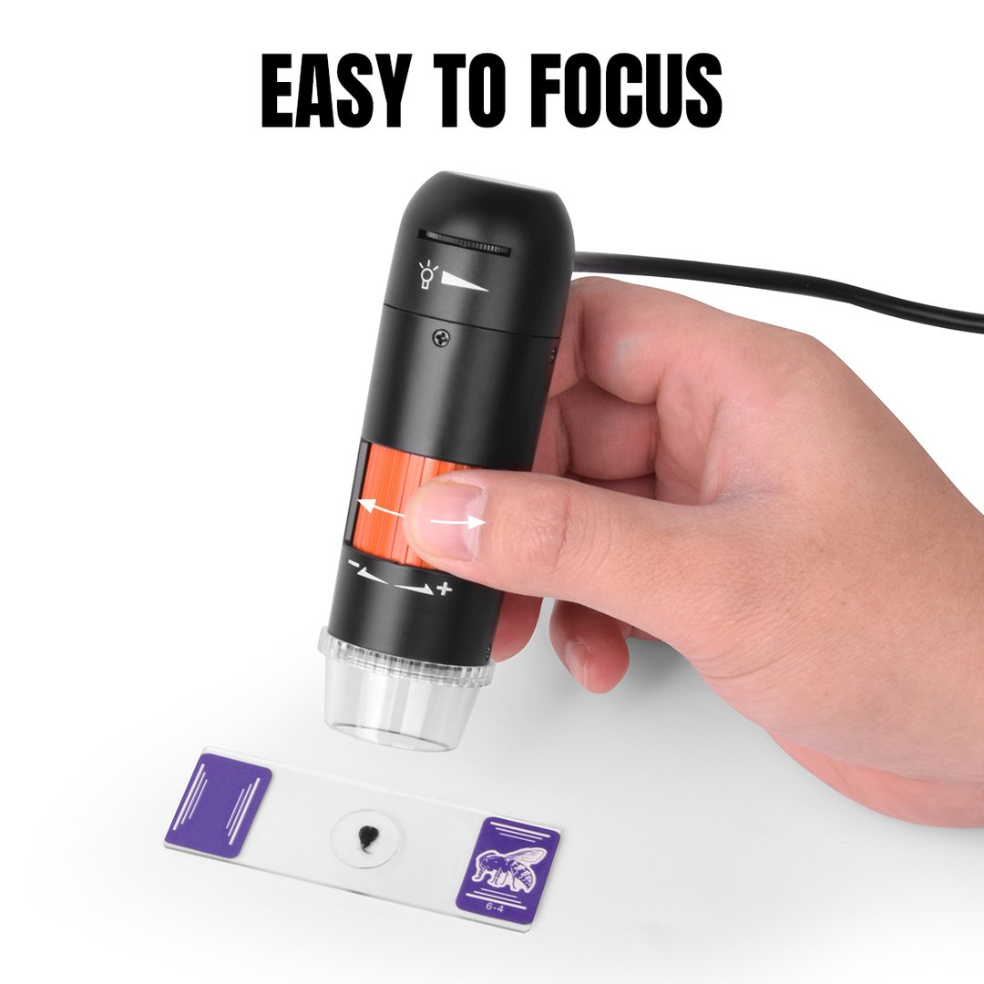 Single-hand focus wheel operation over a prepared microscope slide