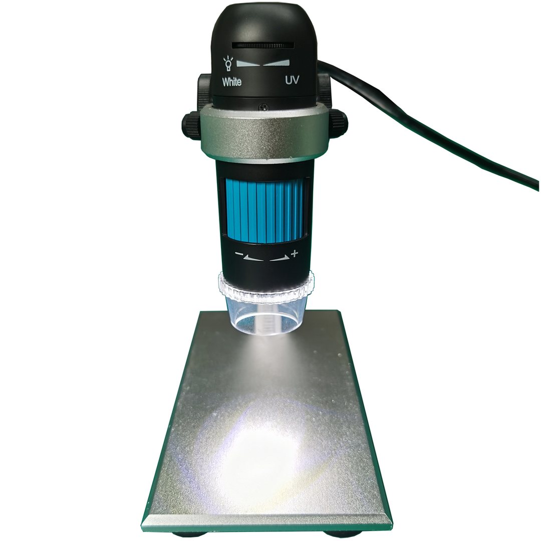 UB-DM020IR on its metal stand, beam aimed at a workpiece